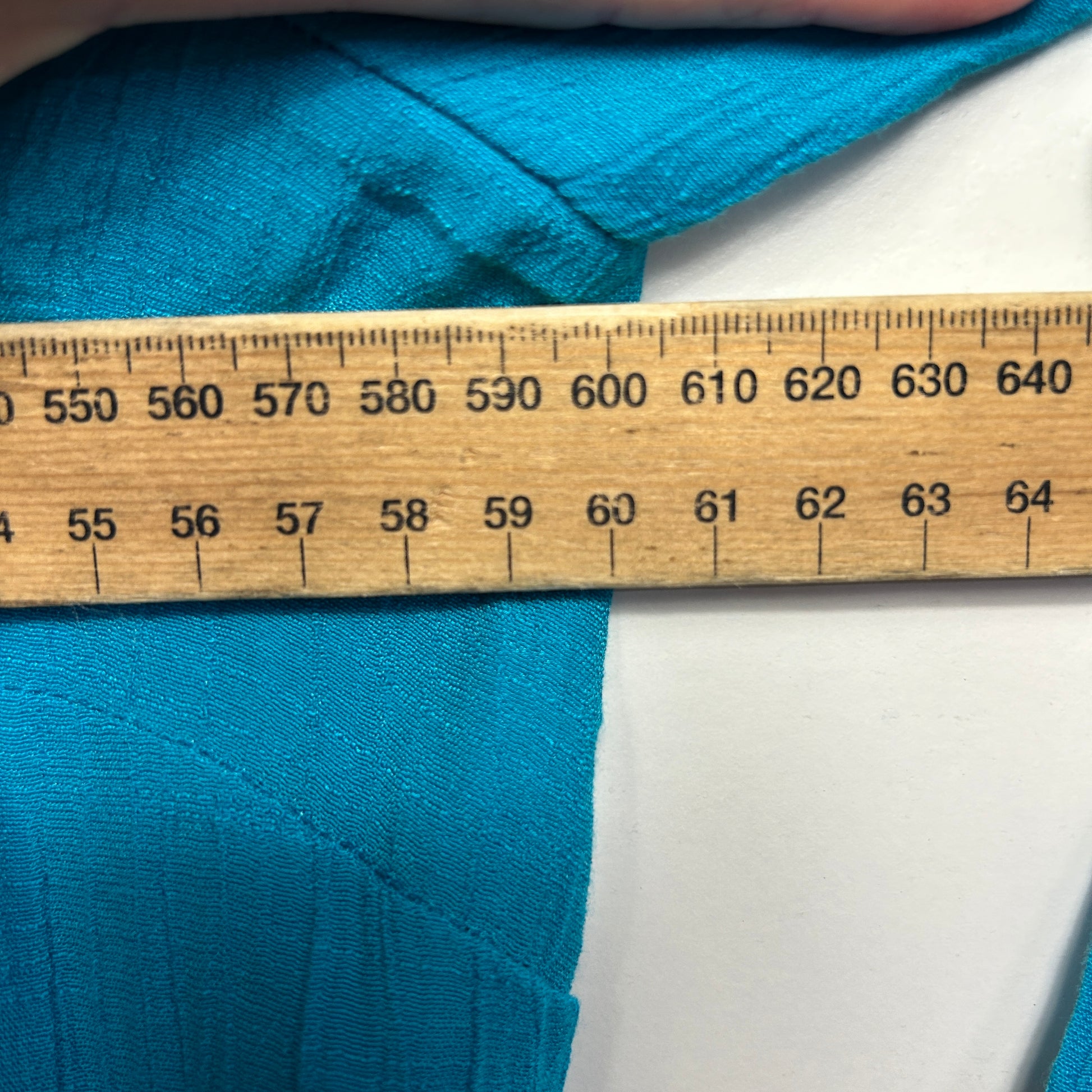 Blue fabric with measuring tape detail view