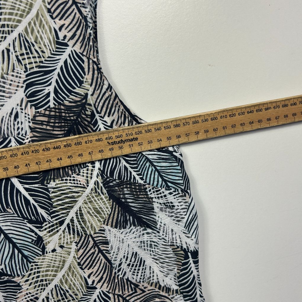 Black and white leaf print fabric detail view with measuring tape