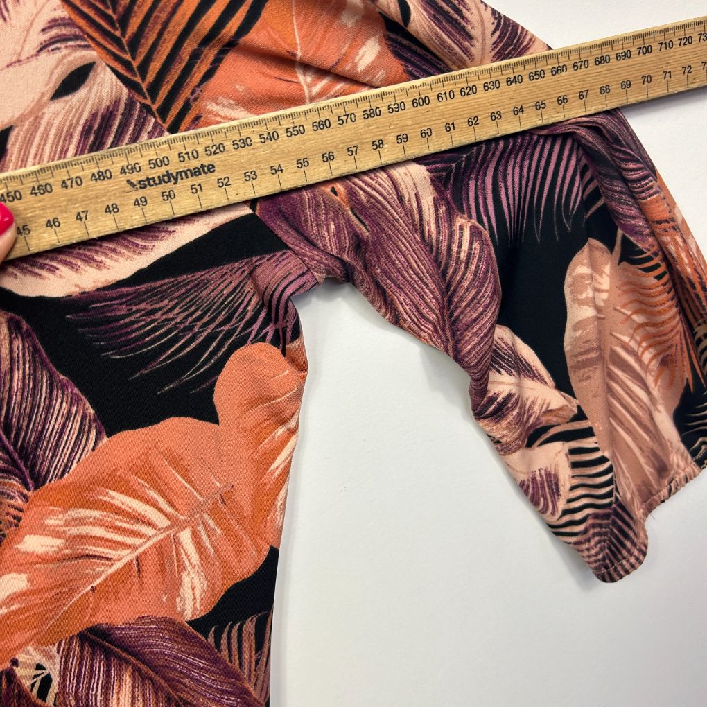 Multicolour leaf print fabric detail view with measuring tape