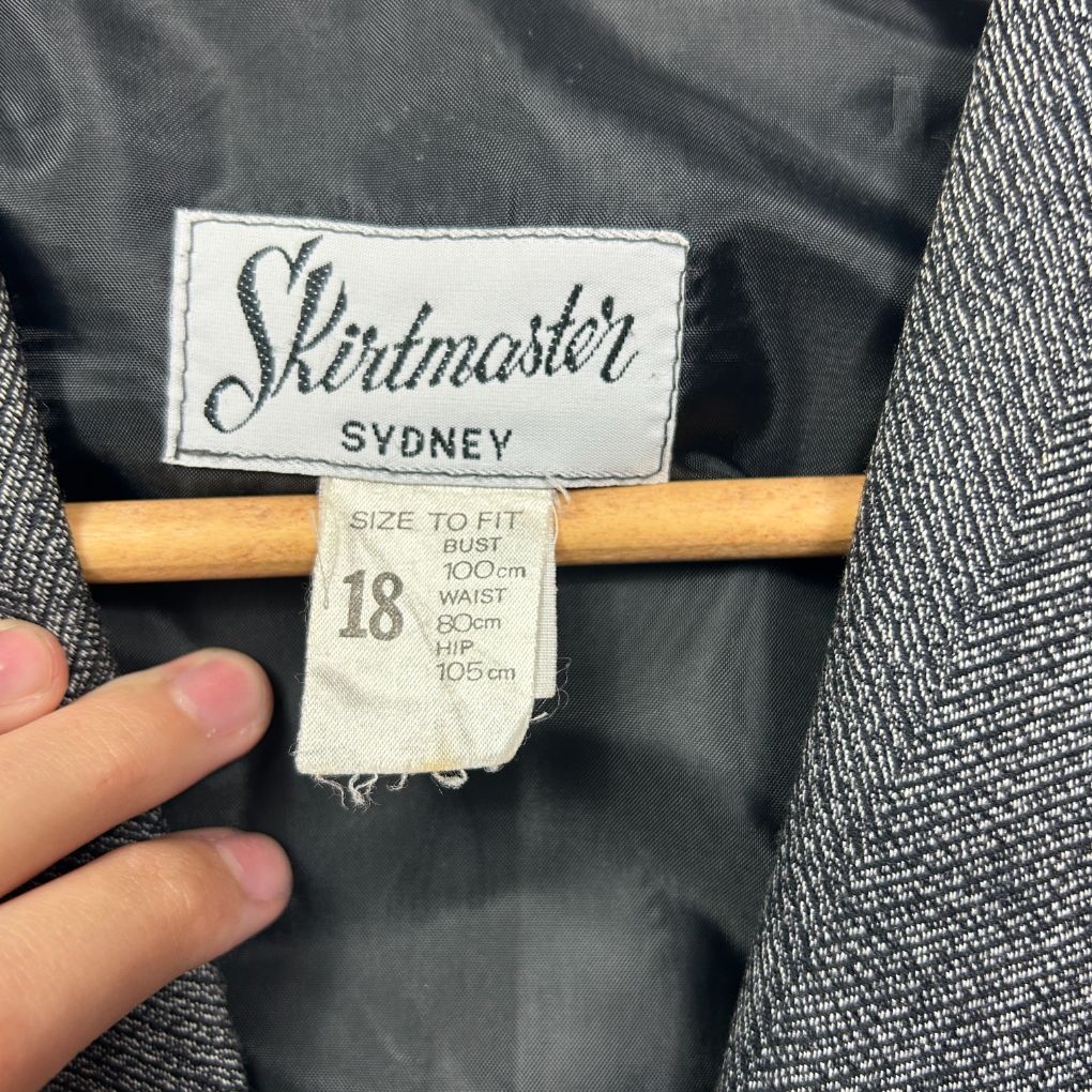 Black jacket label detail showing Shirtmaster Sydney size 18