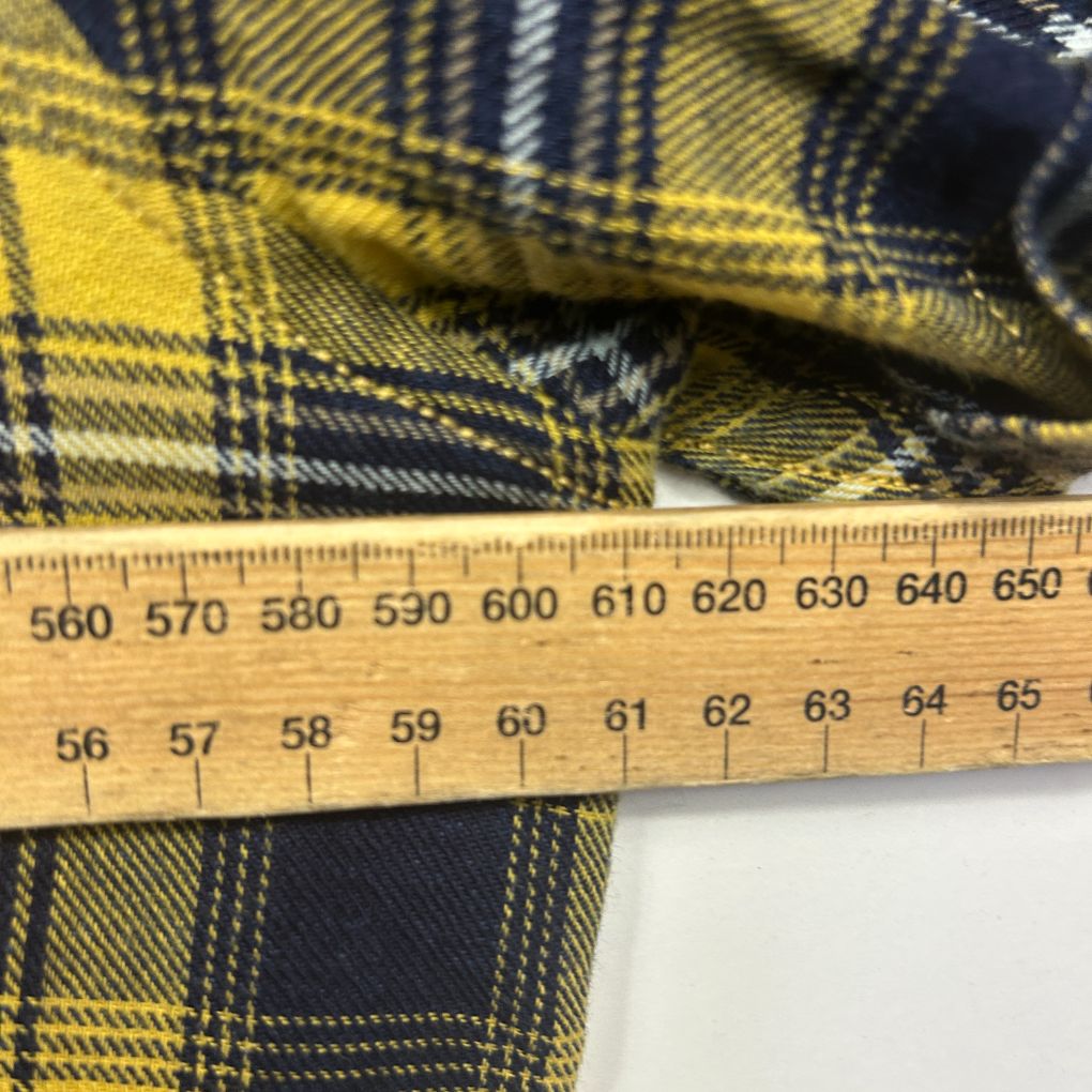 Yellow and navy plaid fabric detail view with measurement ruler