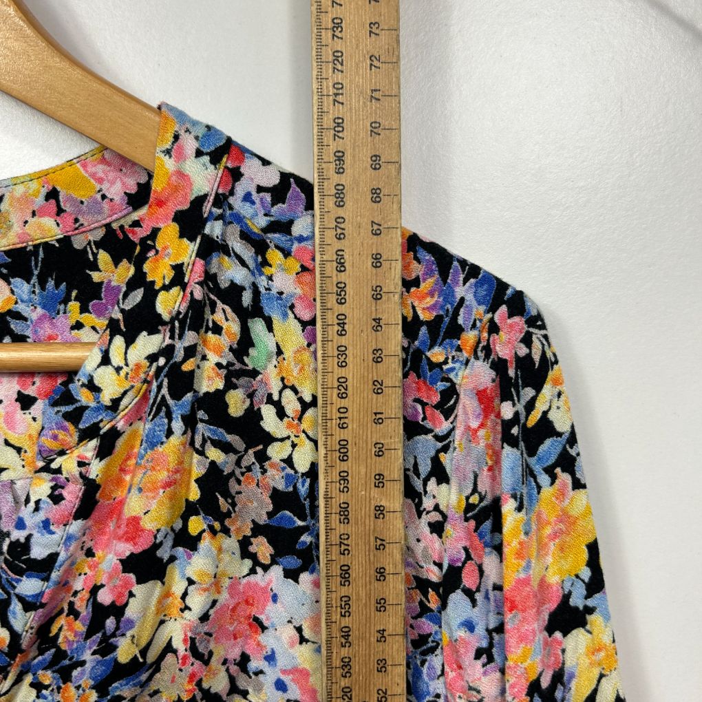 Colorful floral blouse detail view with measuring ruler