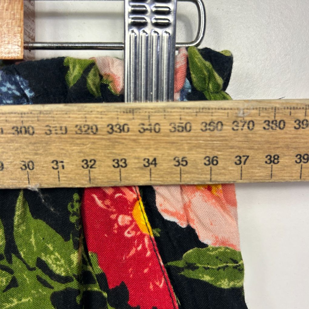Floral fabric detail view with measuring tape