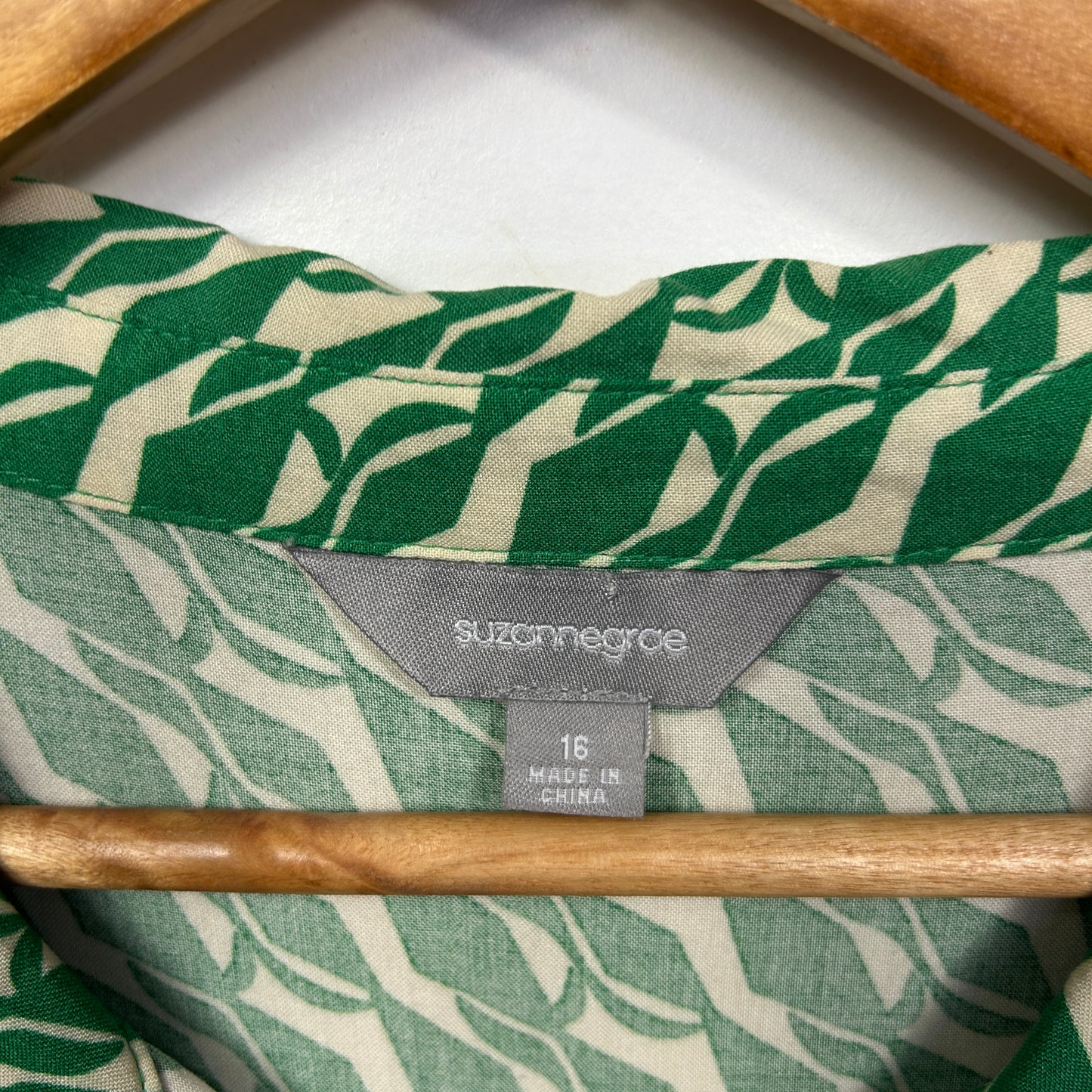 Green and cream leaf pattern shirt label detail