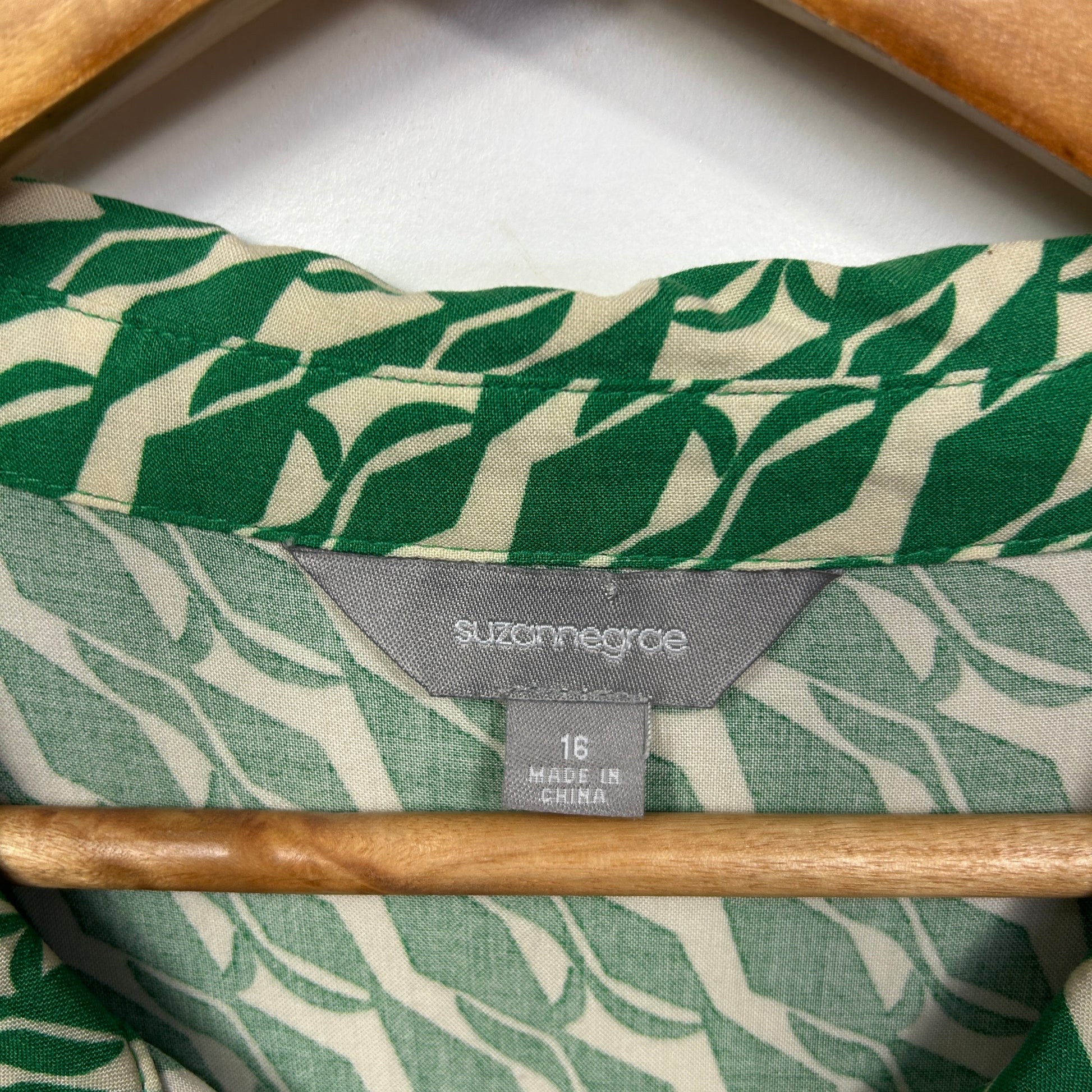 Green and cream leaf pattern shirt label detail