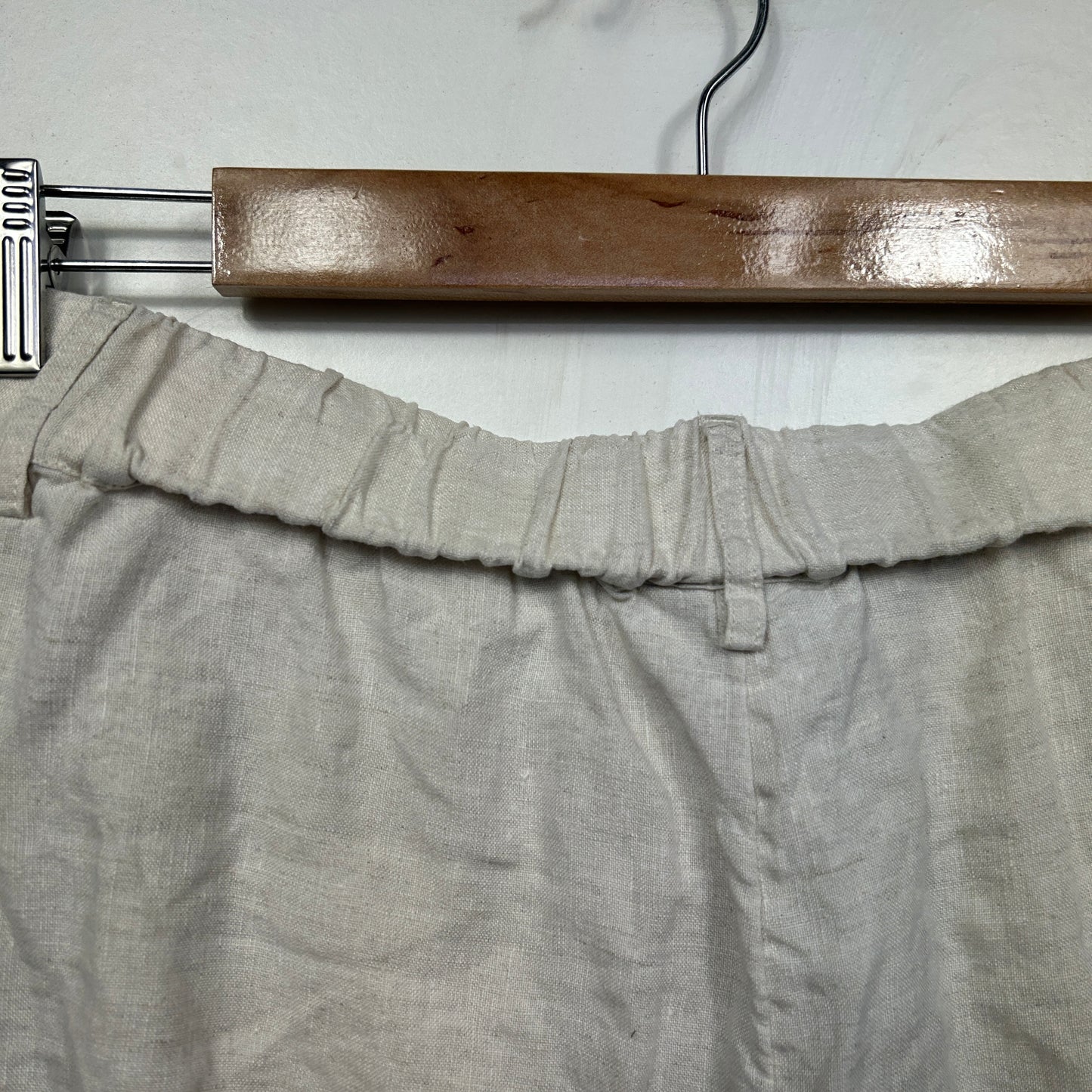 Beige linen pants front view on wooden hanger