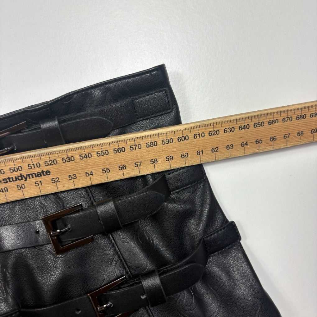 Black leather pants waistband detail with measuring tape
