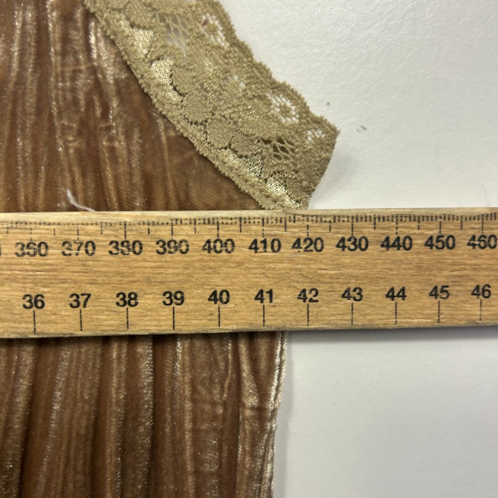 Gold lace trim detail view with measuring scale
