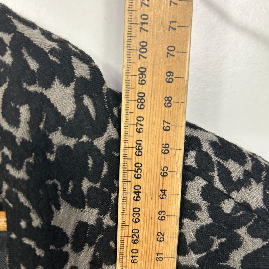 Black and cream patterned fabric detail view with measuring ruler