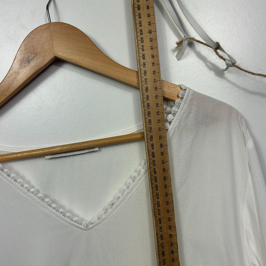 White blouse detail view with ruler