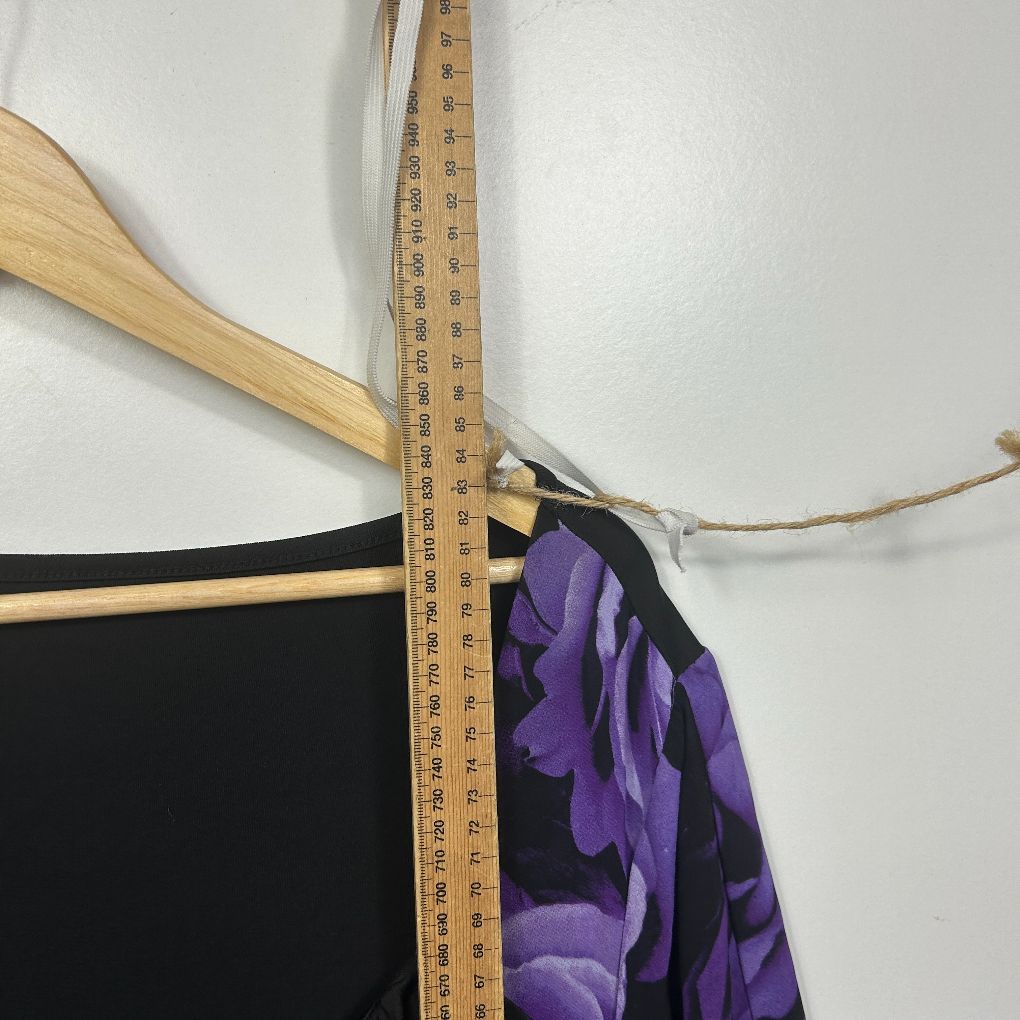 Black top with purple floral sleeve detail view