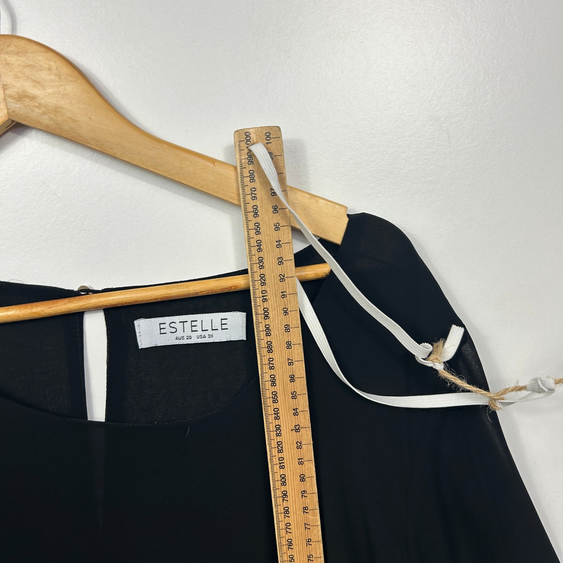 Black pants detail view with measuring tape