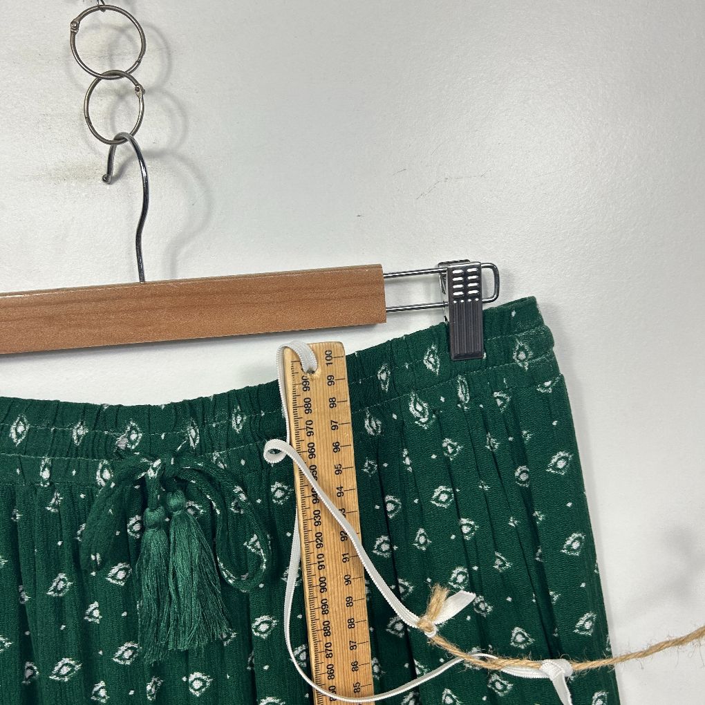 Green floral shorts detail view on hanger