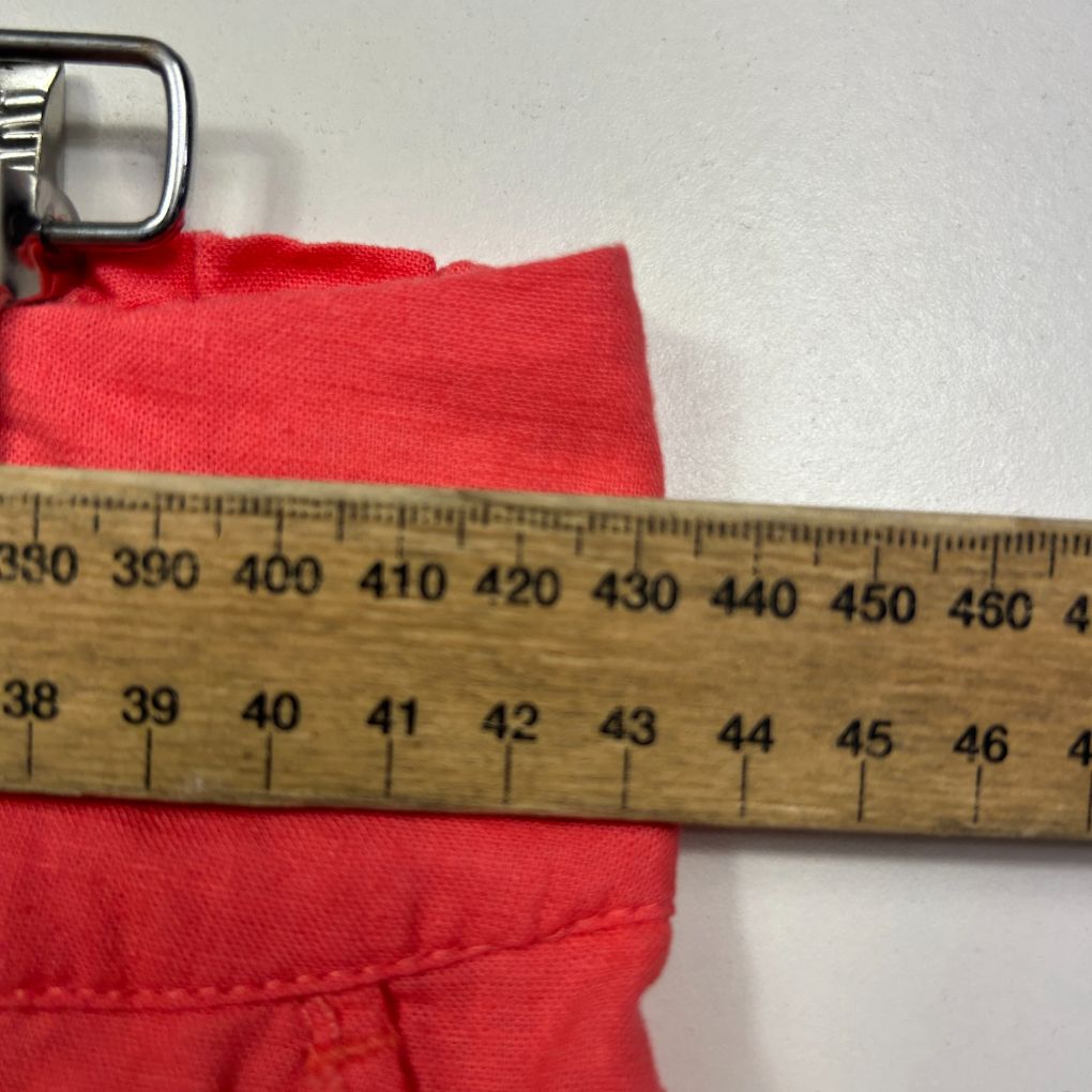 Red fabric detail view with measuring tape