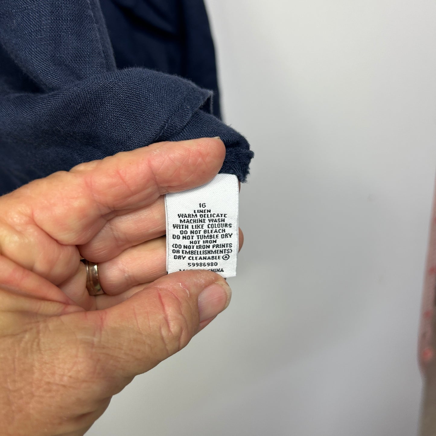 Navy blue garment care label detail view