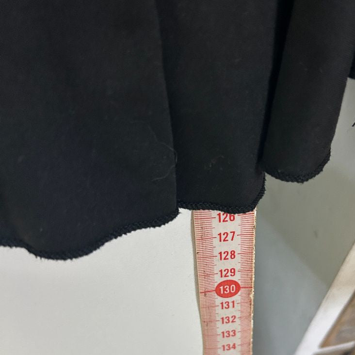 Black pants detail view with measurement tape