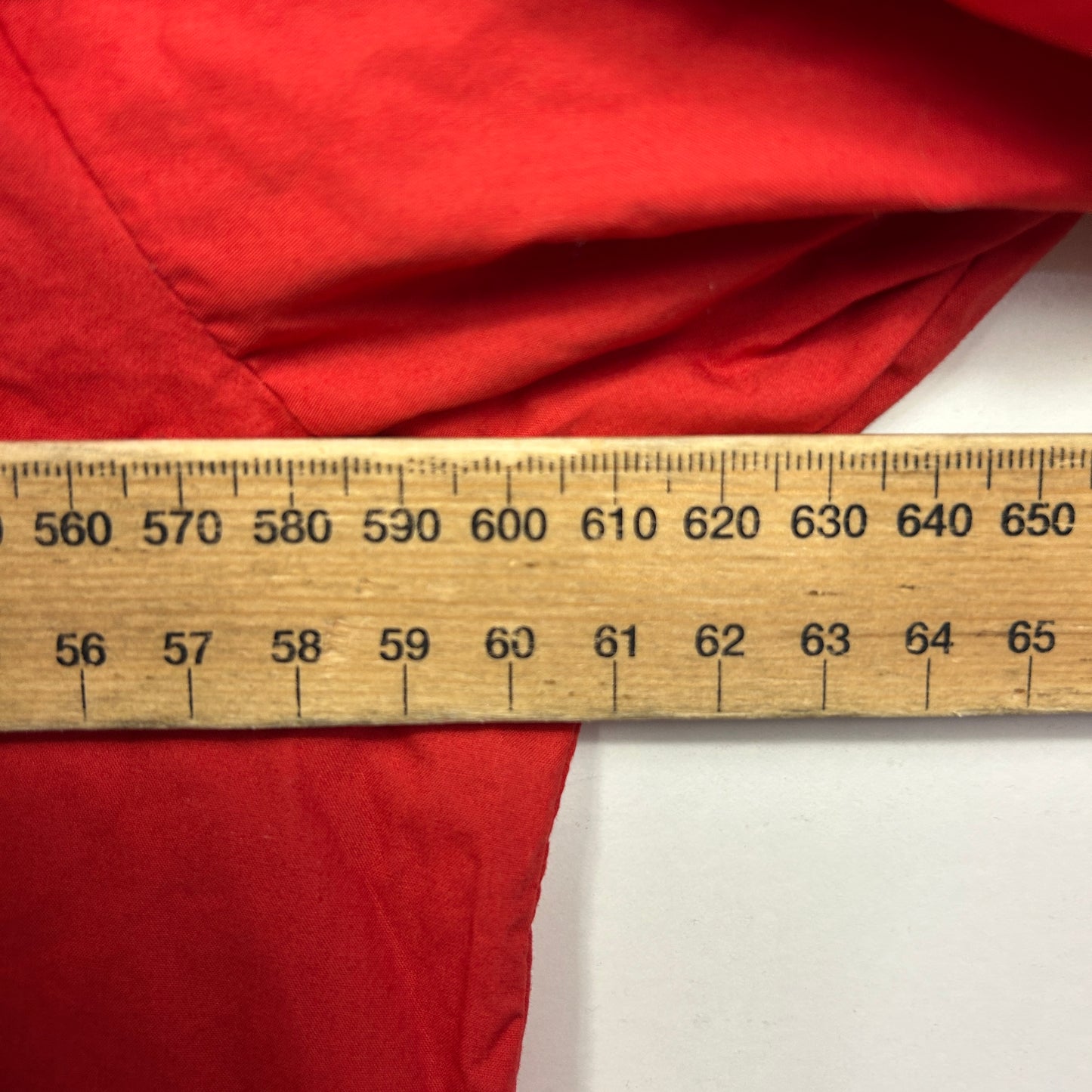 Red fabric with measurement ruler detail view