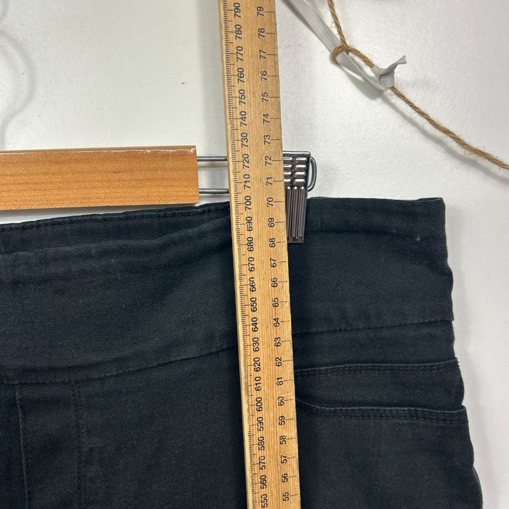 Dark navy jeans with measuring tape detail view