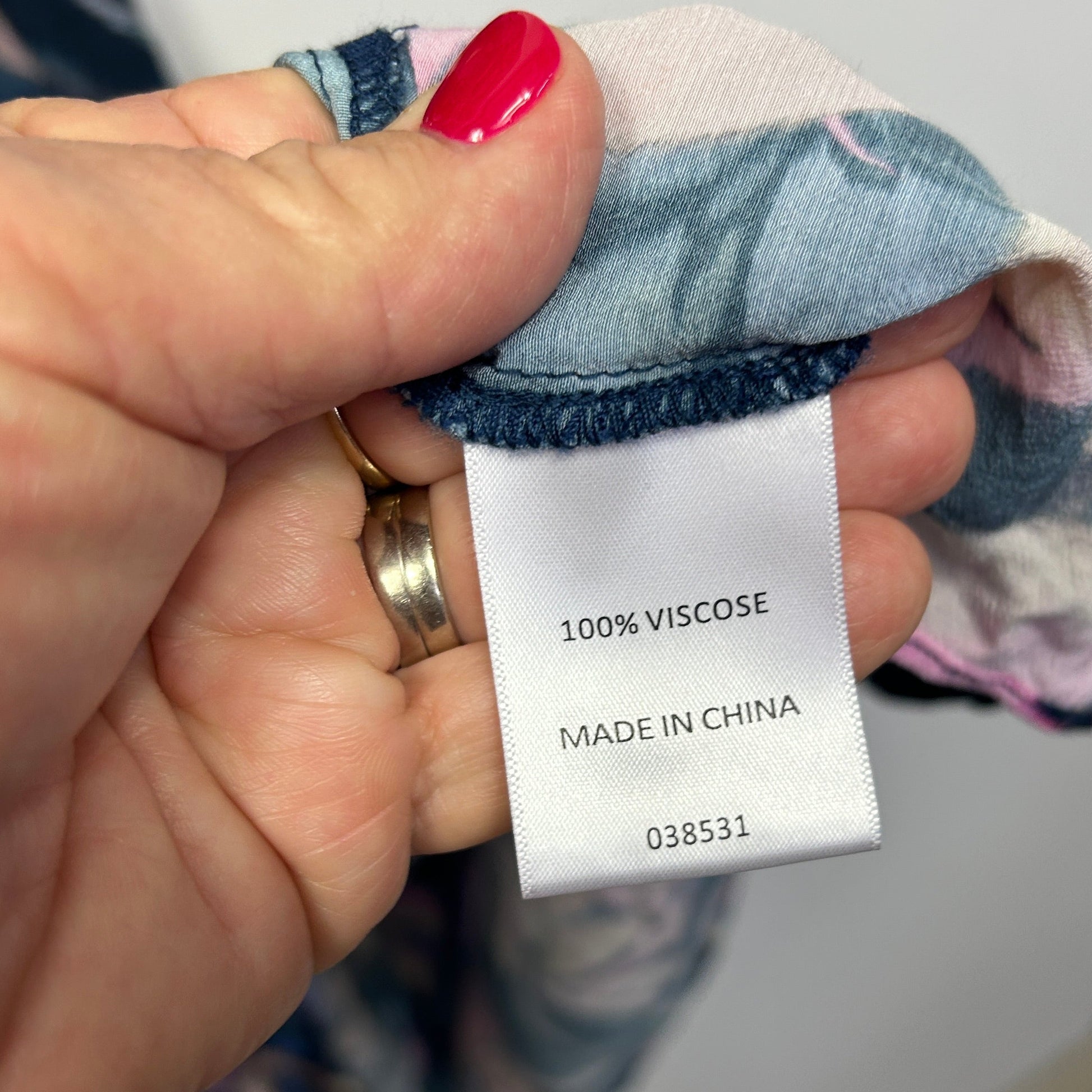 Clothing label detail showing 100% viscose fabric content and made in China