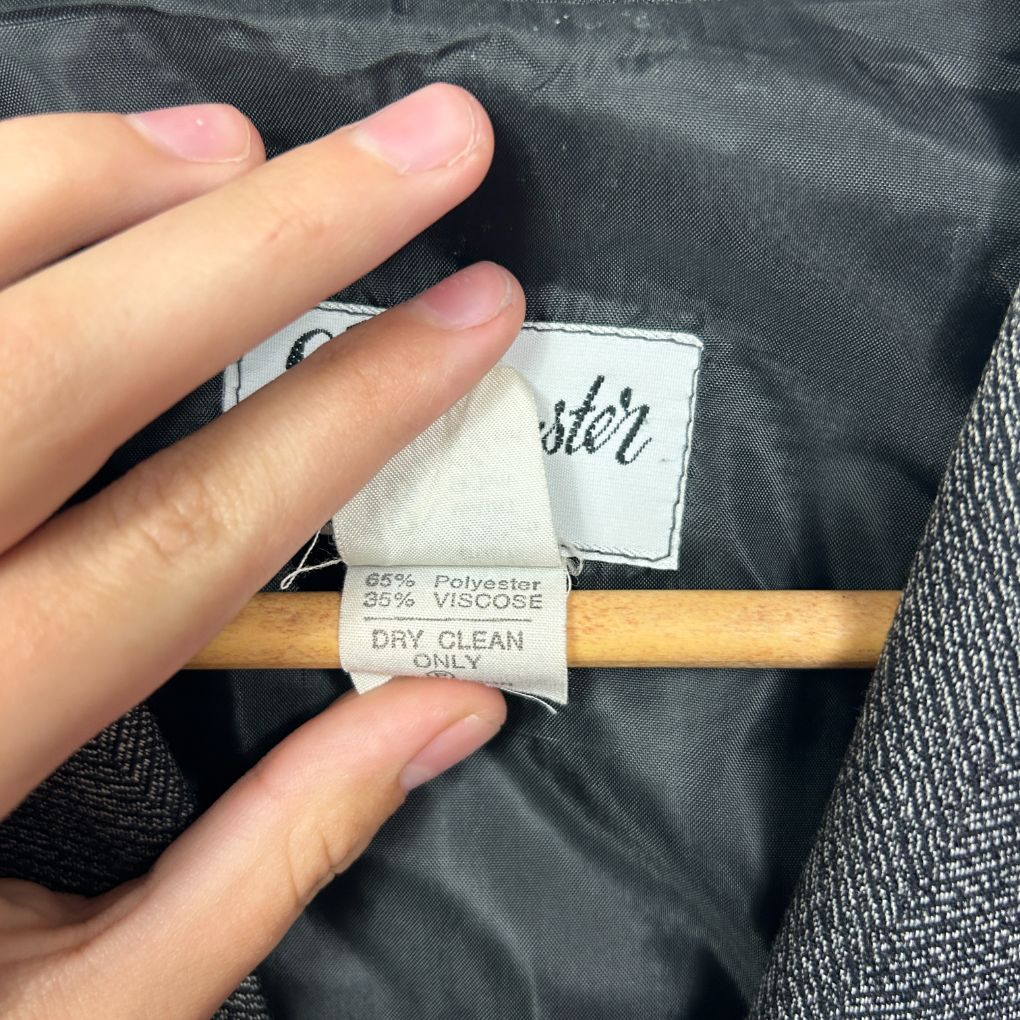 Black jacket with care label detail view