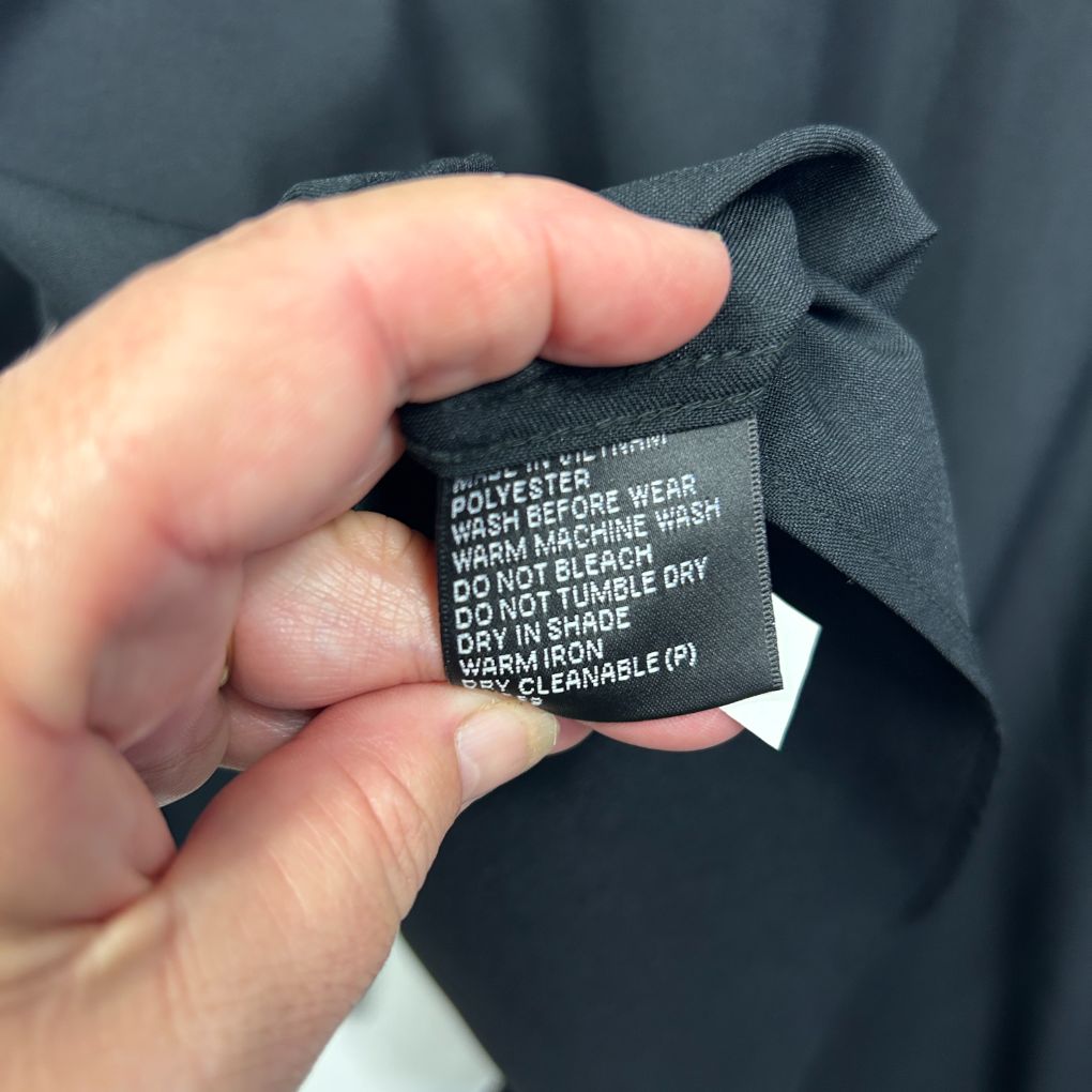 Black garment care label detail view