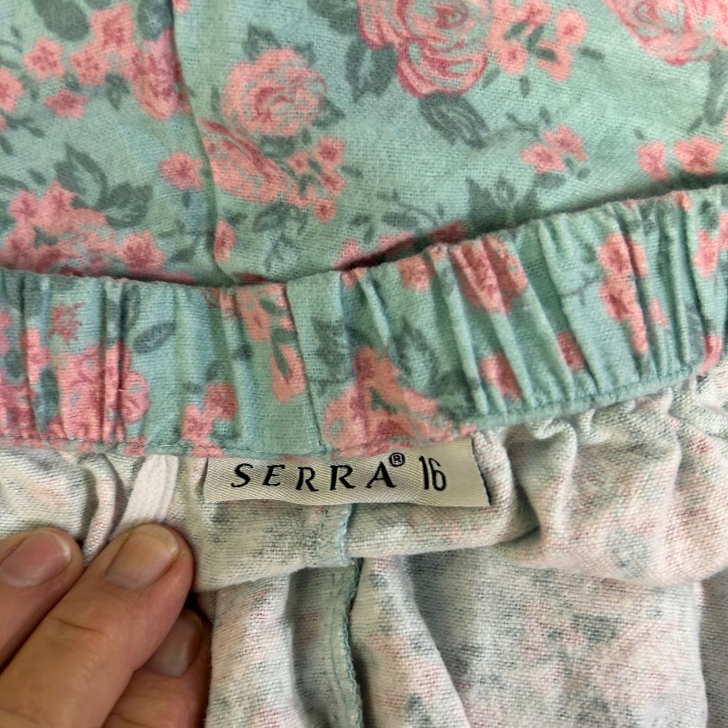 Green floral dress detail view showing label
