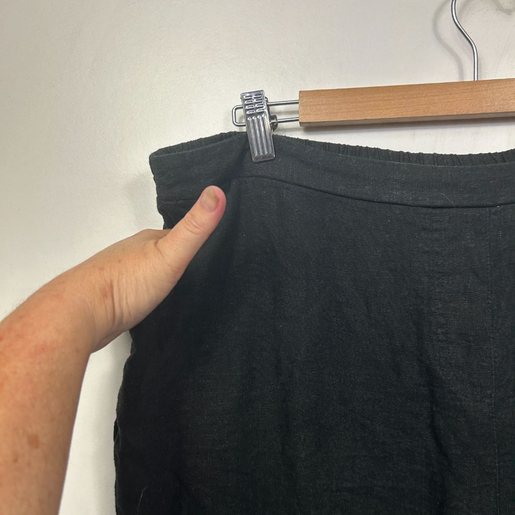 Black shorts front view on hanger