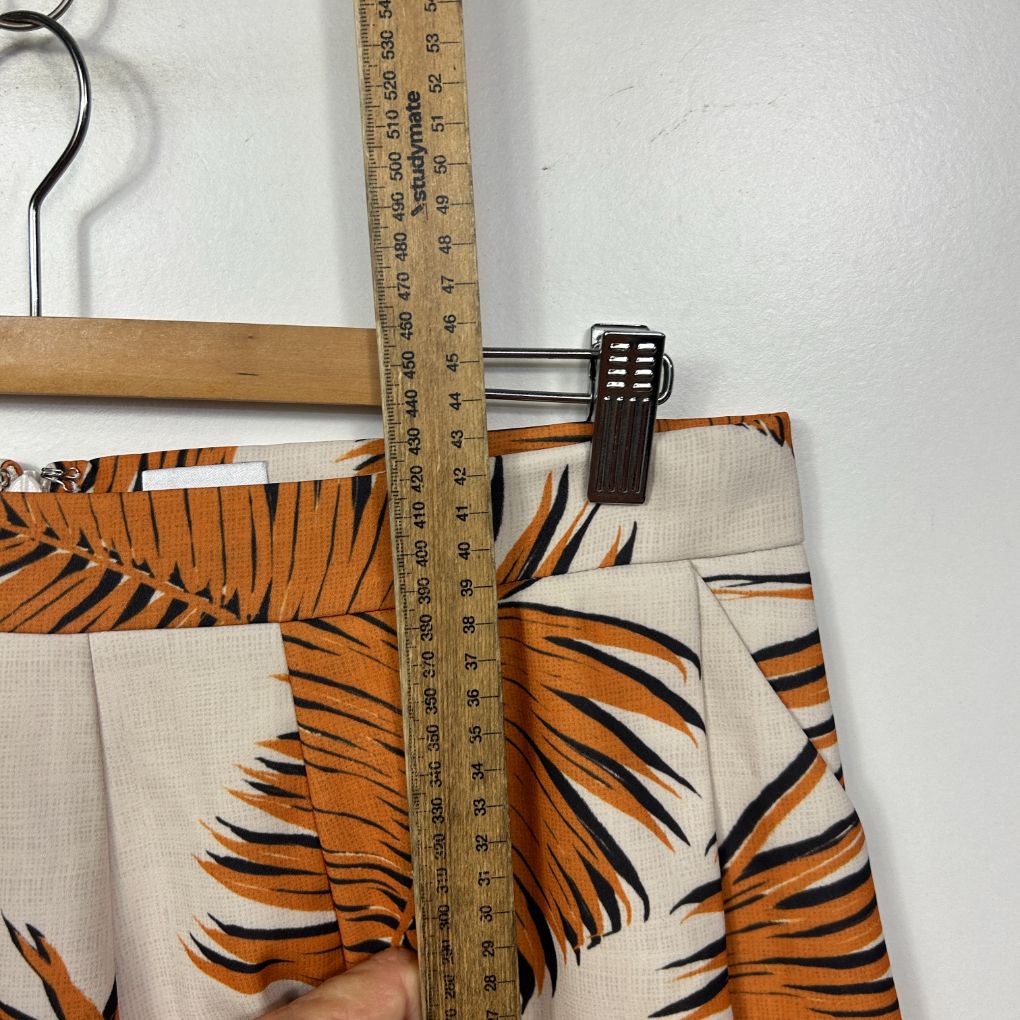 Cream and orange tiger stripe print shorts detail view with measuring tape