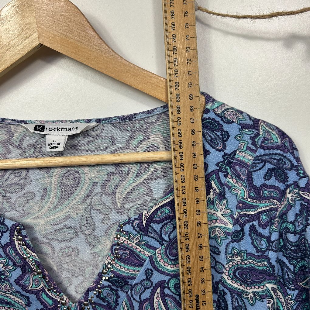 Blue paisley print top detail view with measuring tape