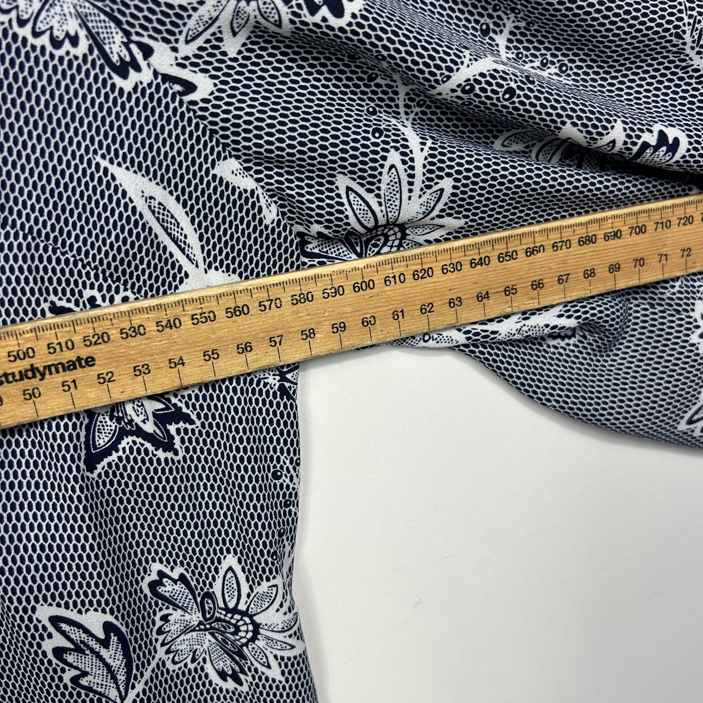 Black and white floral fabric with measuring tape detail view