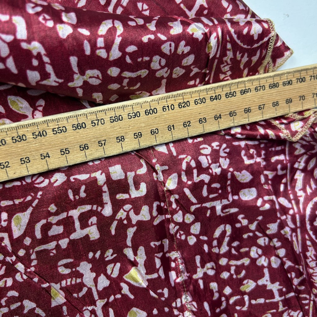 Burgundy fabric with white abstract pattern detail view