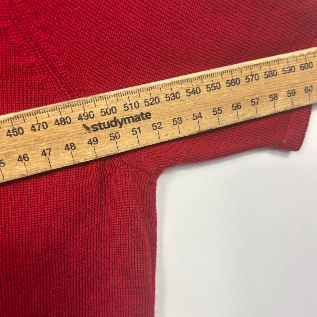 Red fabric detail view with measuring tape