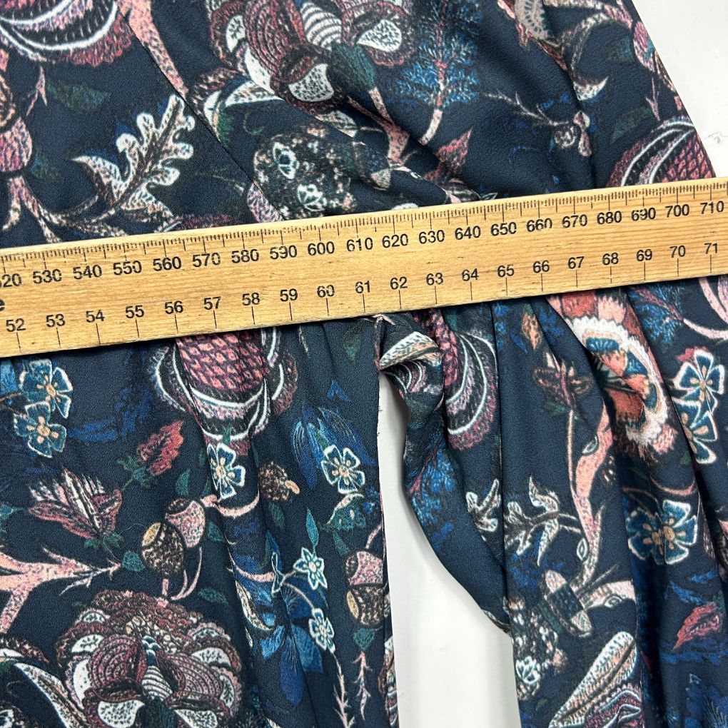 Navy floral dress detail view with measuring tape