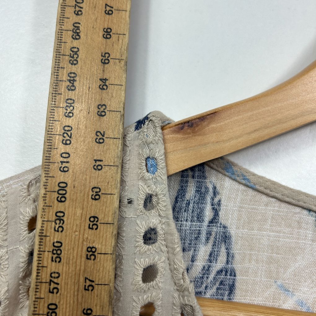 Beige linen garment detail view with measurement scale