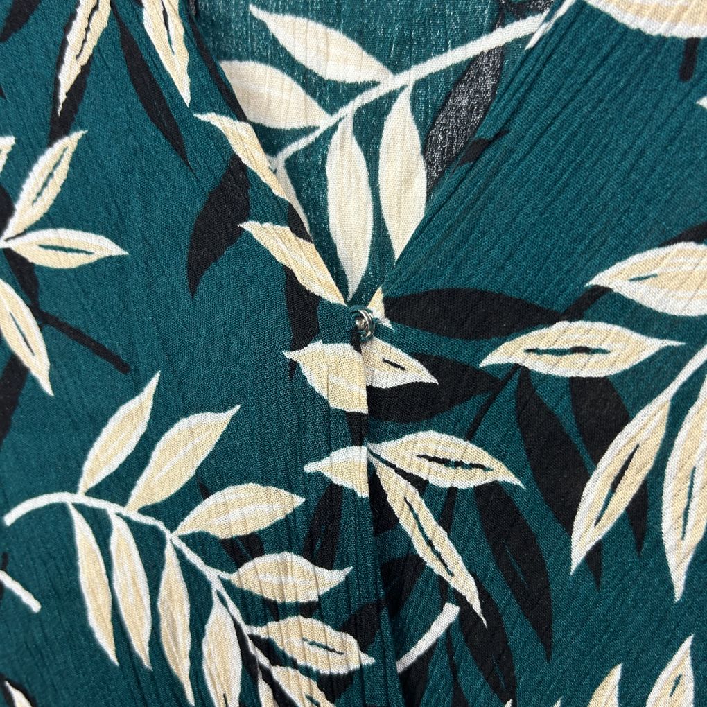 Teal fabric with cream and black leaf pattern detail view