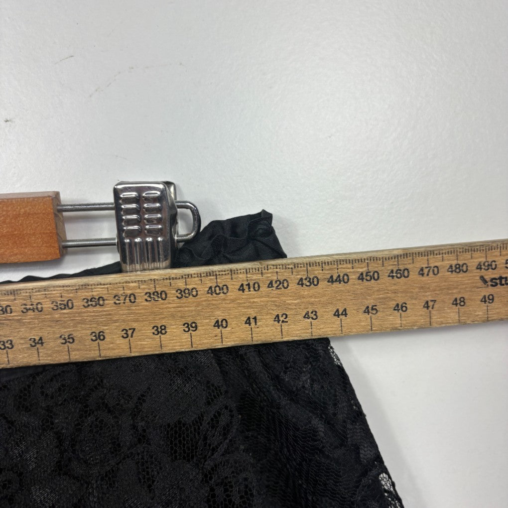 Black textured fabric detail view with measuring tape
