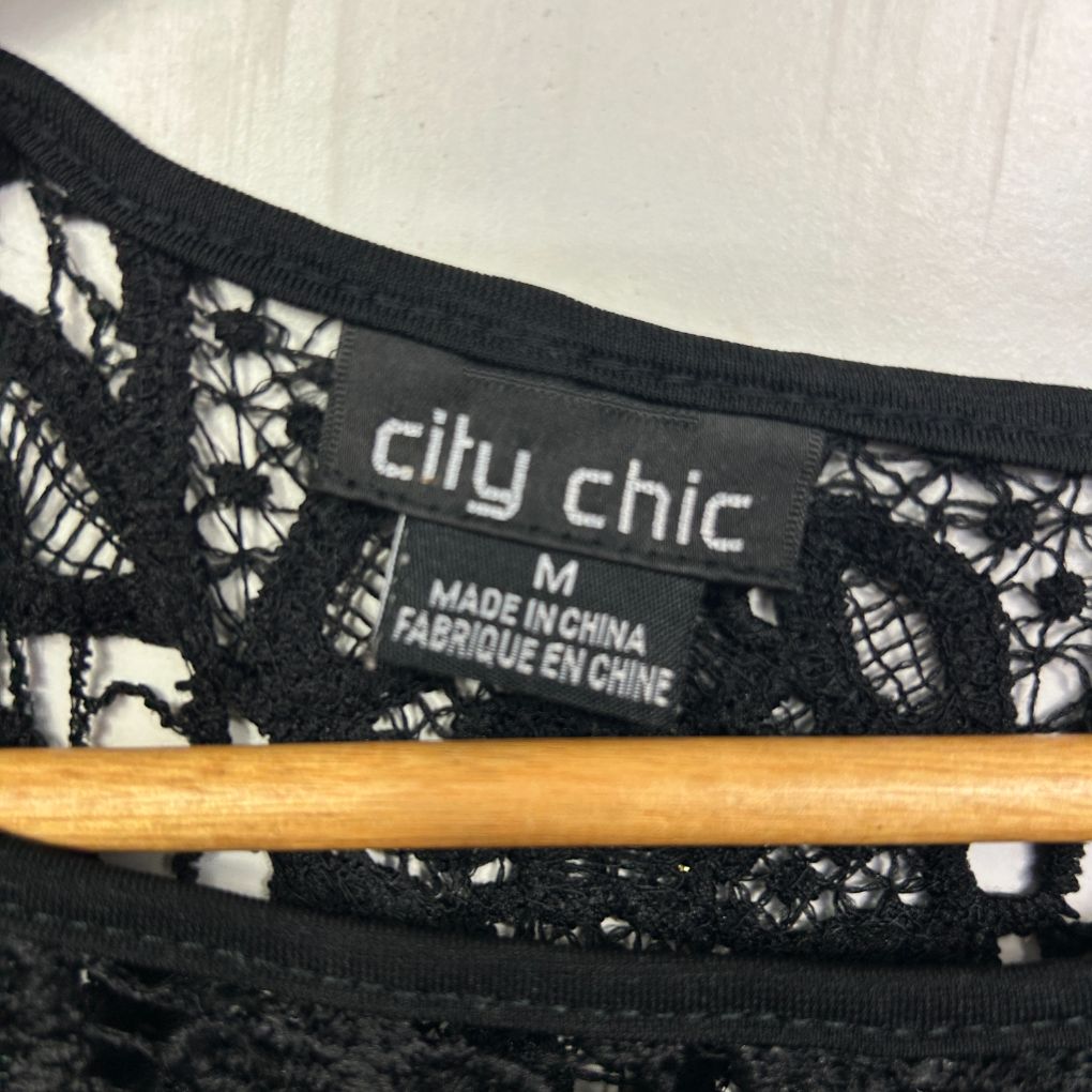 Black lace bralette detail view with label