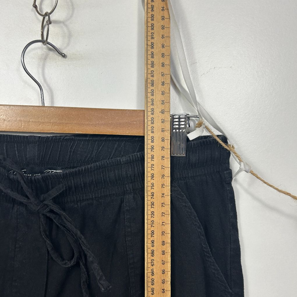 Black pants detail view with measuring tape