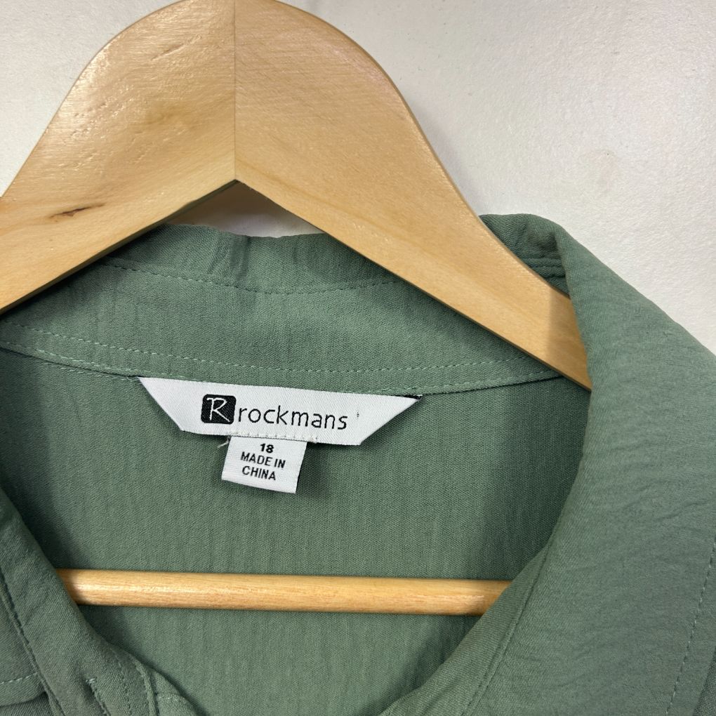 Green shirt front view on wooden hanger