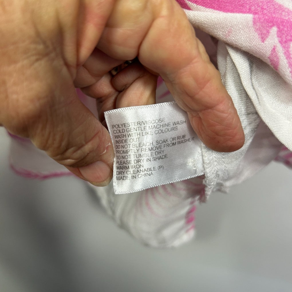 Pink and white clothing label detail view