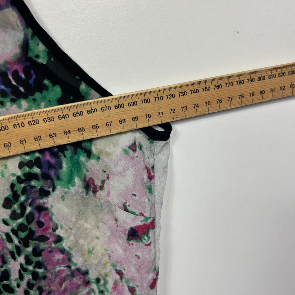 Floral print top detail view with measuring tape