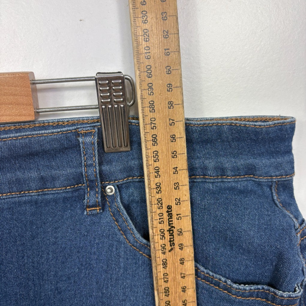 Blue denim jeans waistband detail view with measuring tape and belt