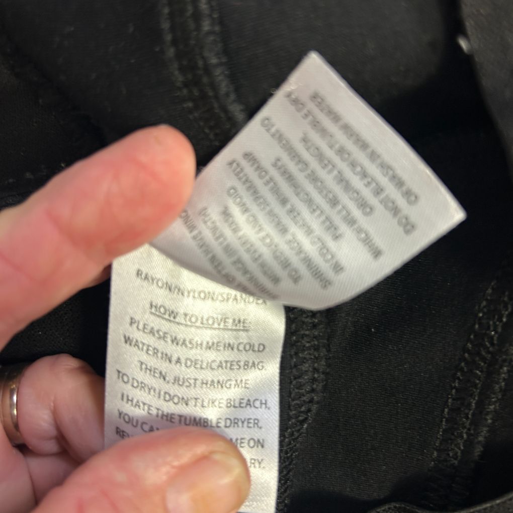 Black garment care label detail view