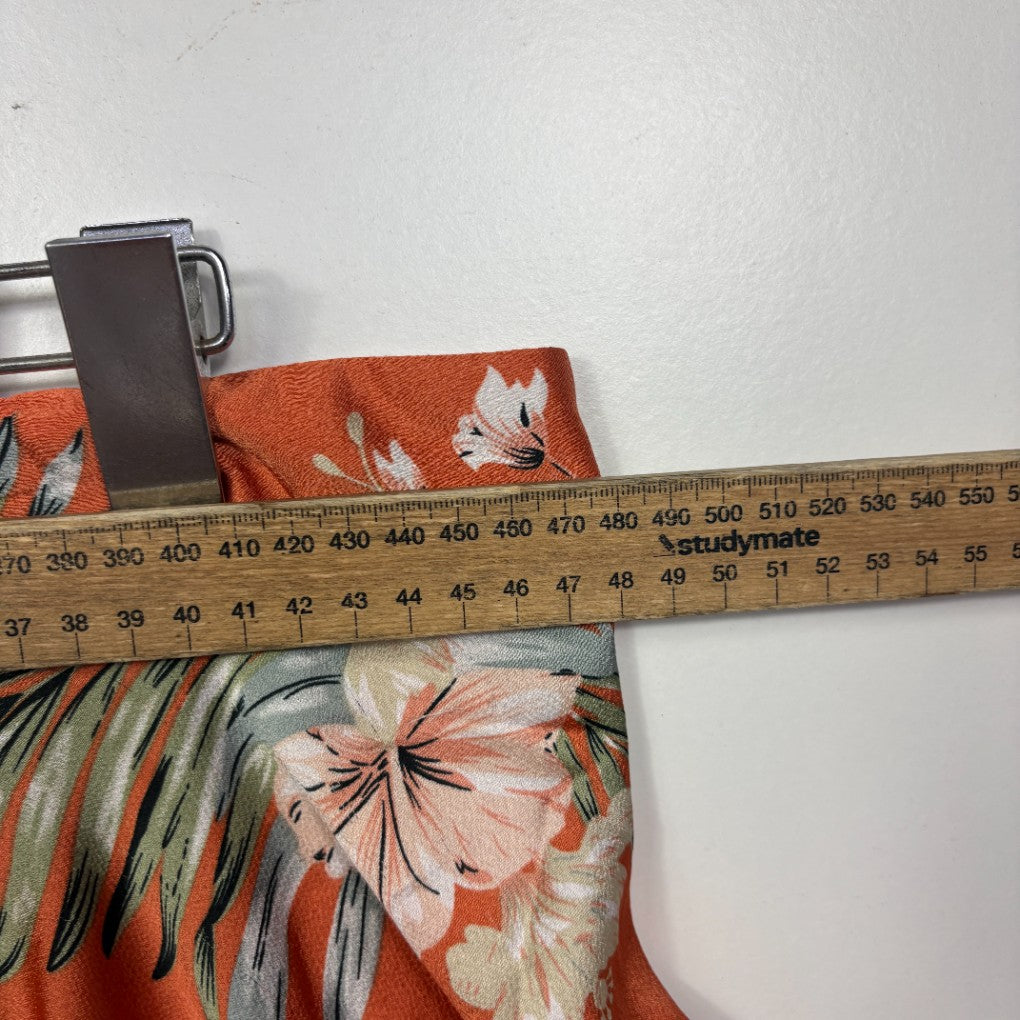 Orange floral fabric with measuring tape detail view