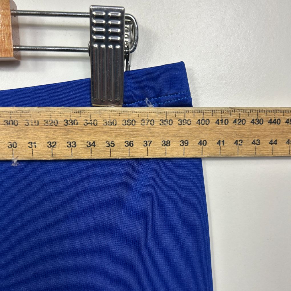 Blue fabric measured with tape measure detail view