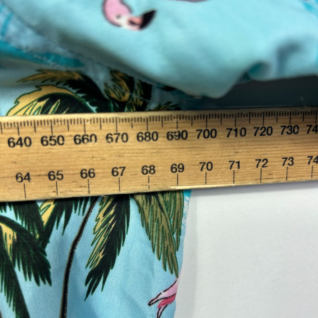 Blue fabric with palm tree pattern detail view with measurement ruler