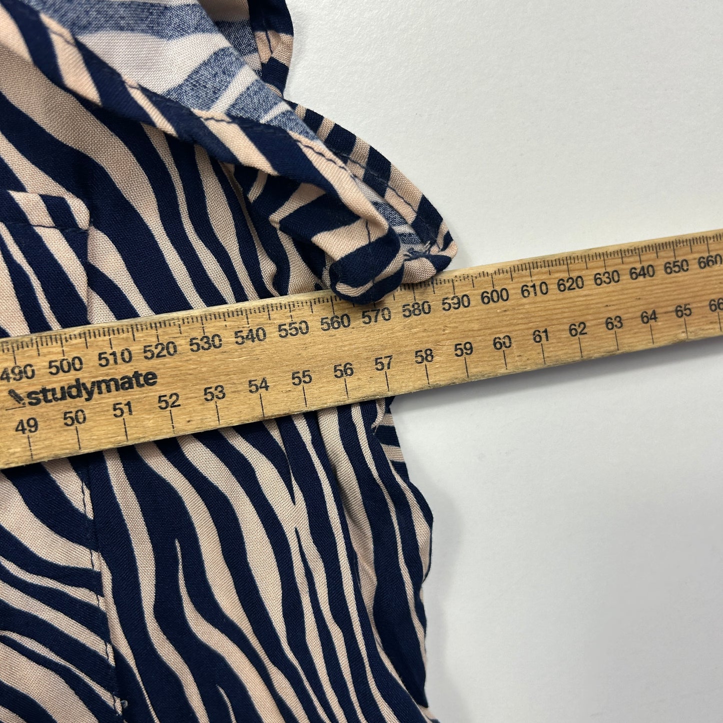 Navy and cream zebra striped fabric detail view with measuring tape