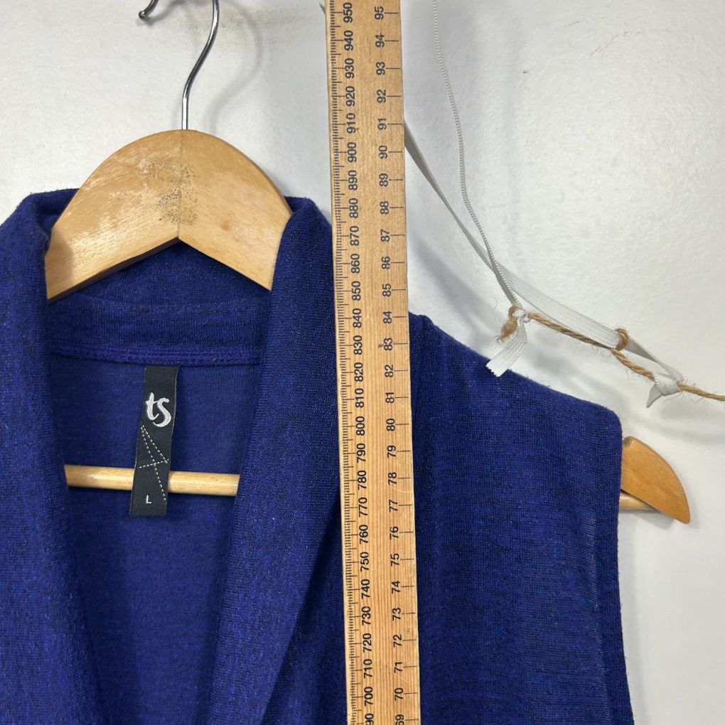 Blue cardigan front view on wooden hanger with measuring tape