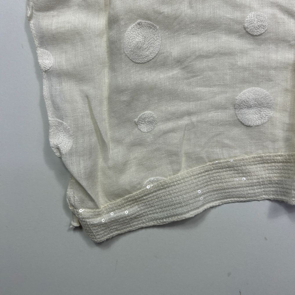 Cream blouse detail view showing textured circular embellishments