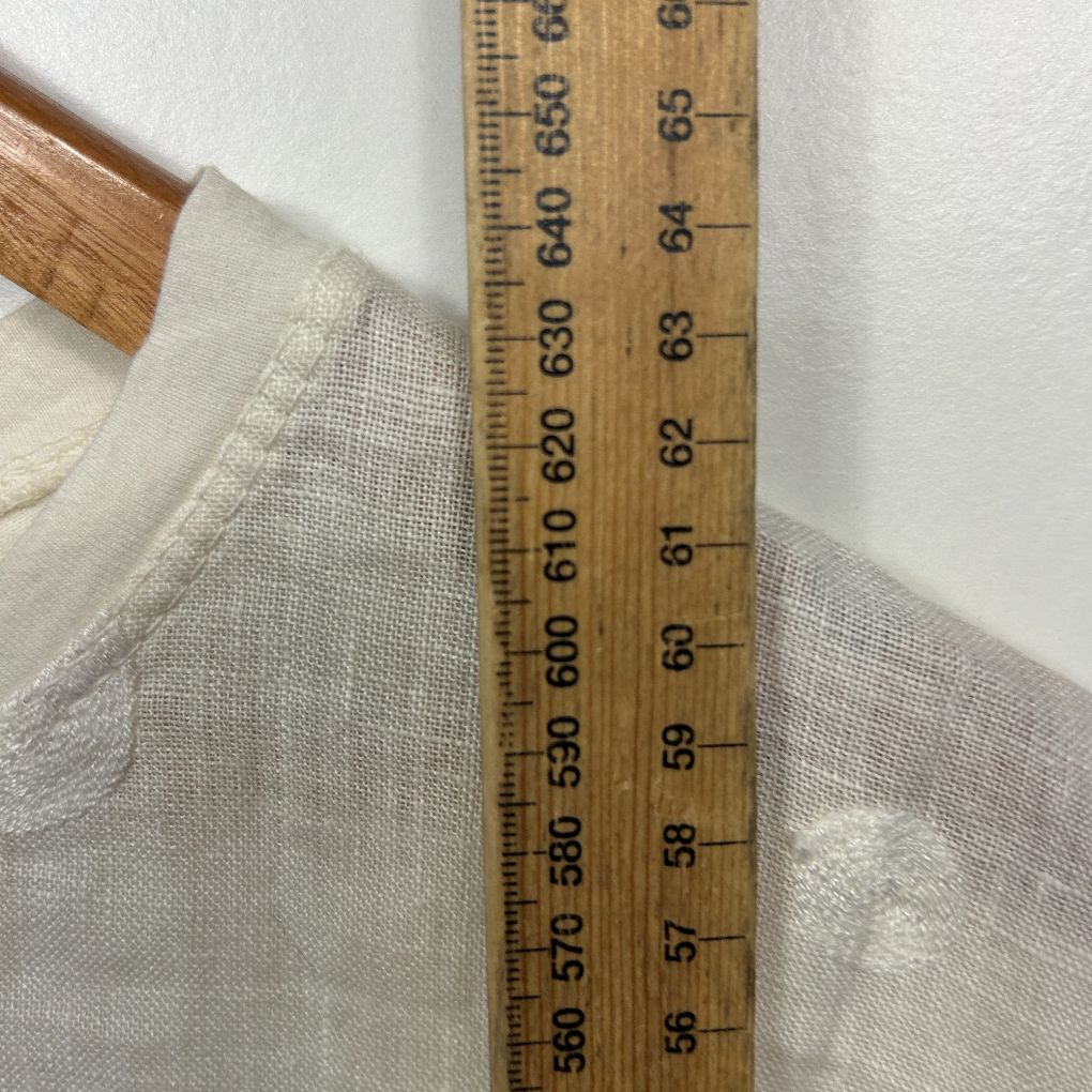 Cream knit sweater detail view with ruler measurement